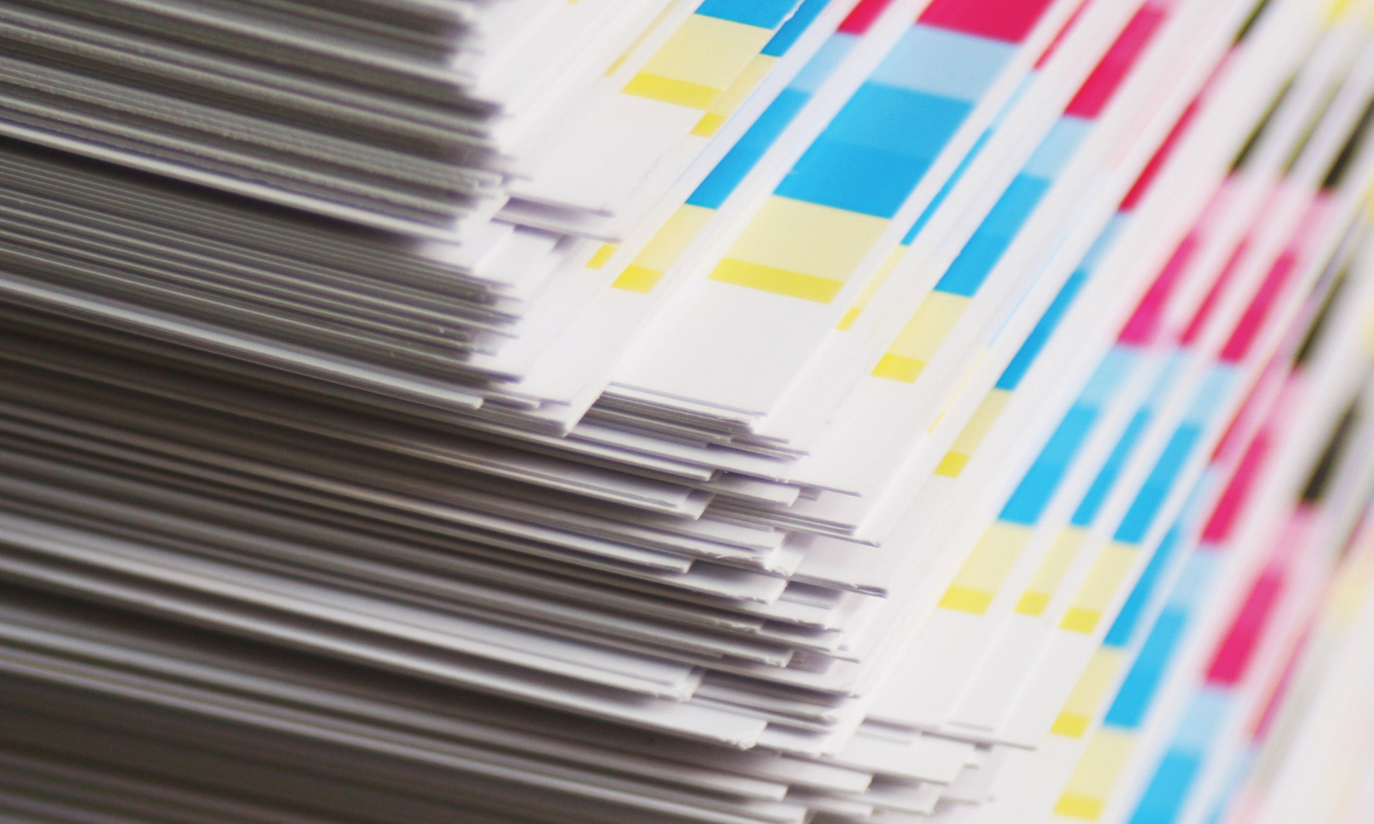 Stacked colour-checked print sheets